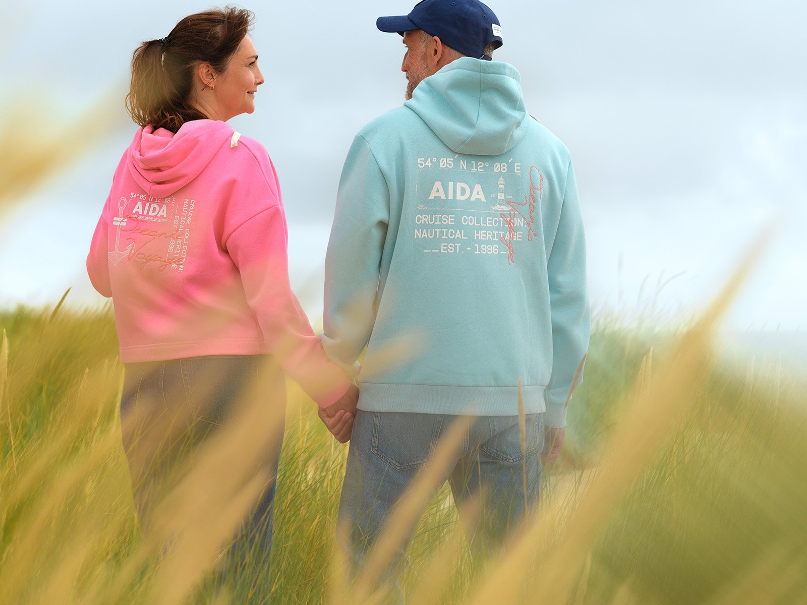 Frau und Mann händchenhaltend mit Kleidung der AIDA Oceanic Voyage Cruise Collection