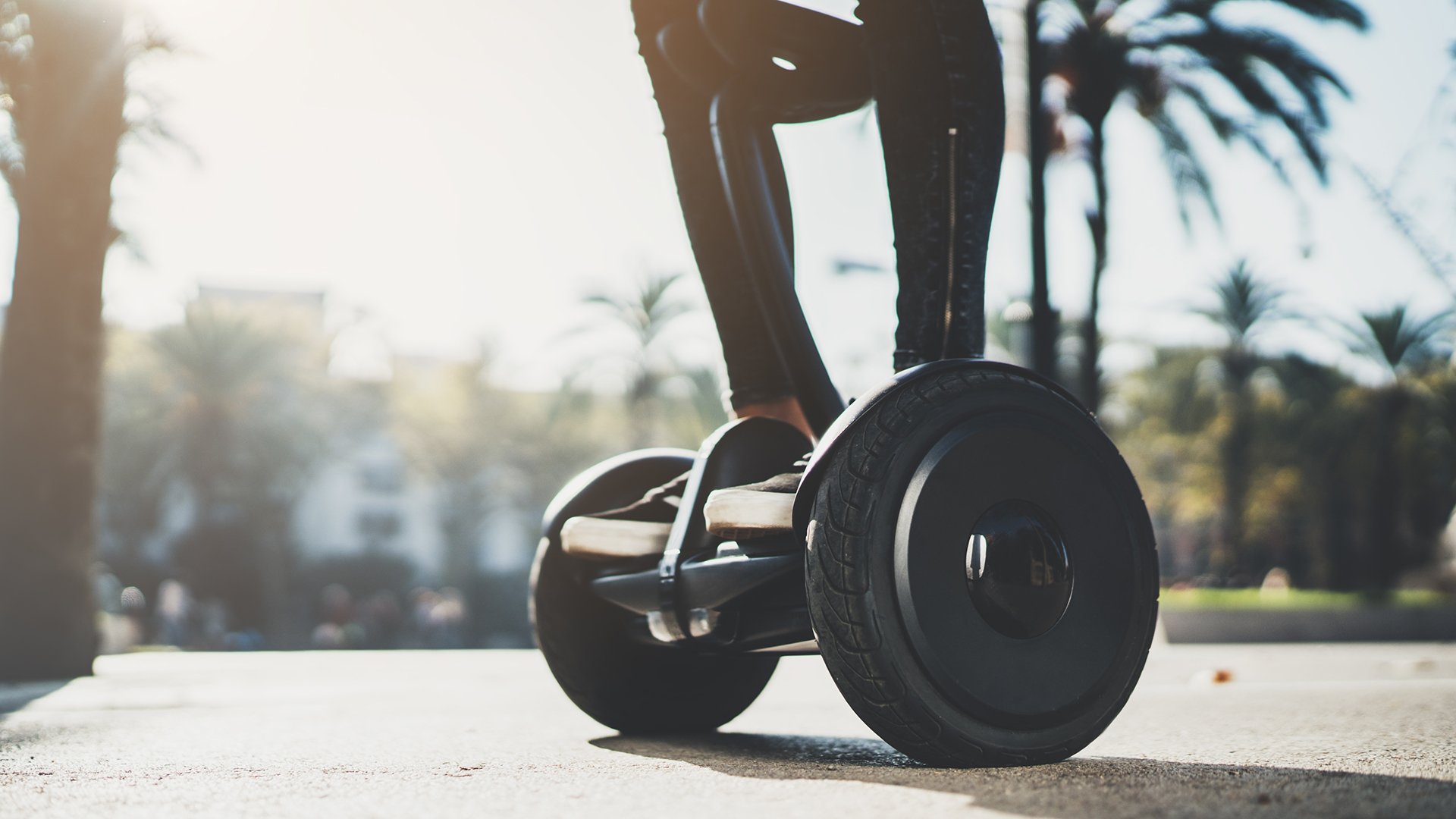 Young hipster girl standing on electric hoverboard at sunny day in Europe, activity holidays, environment and ecology concept, active woman riding self-balancing scooter at holiday, enjoyment lifestyle