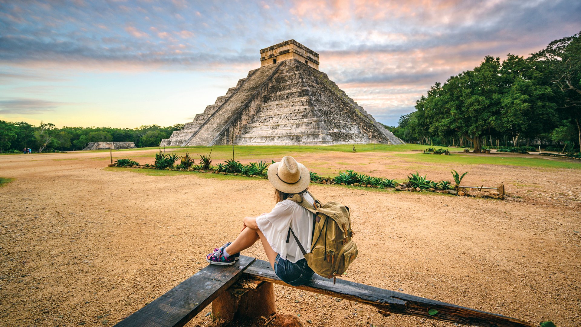 One woman admiring Kukulkan pyramid at Chichen-Itza archaeological site, Yucatan, Mexico