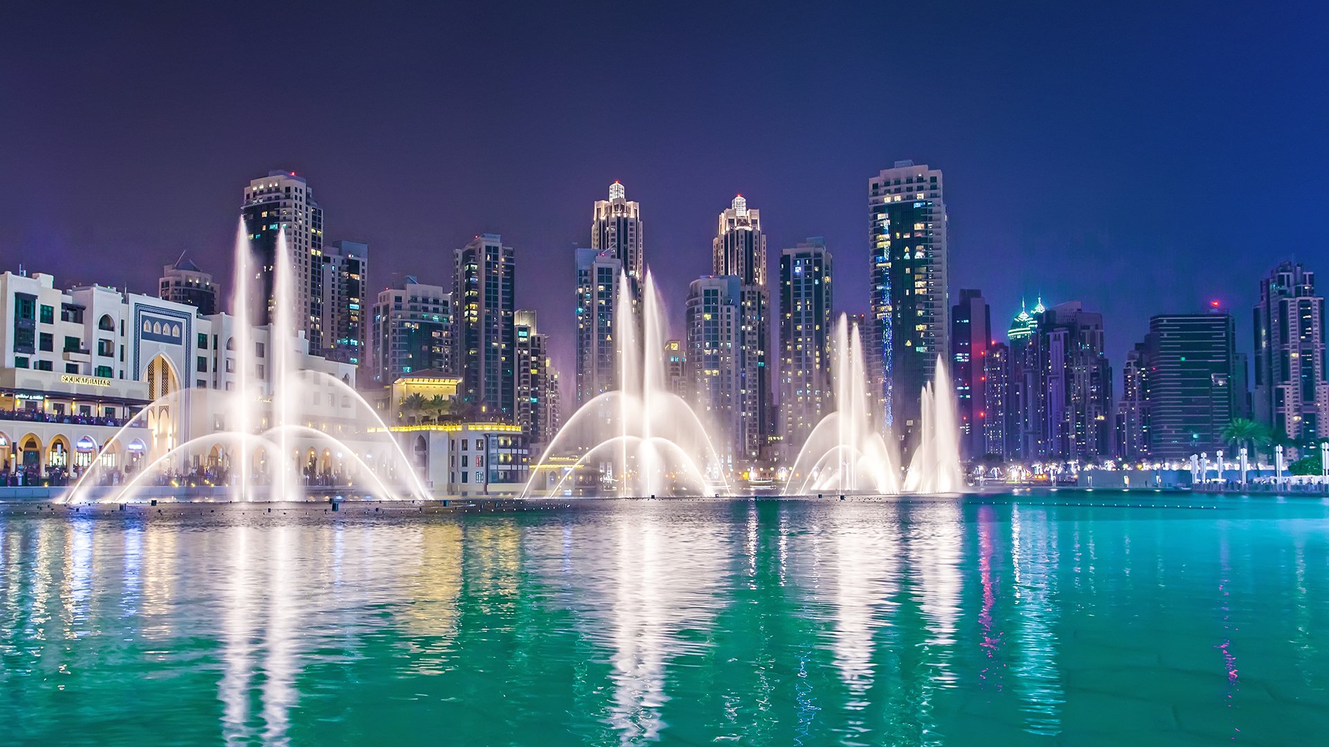 Dubai, UAE - May 12, 2014: Dubai Fountain is world largest choreographed fountain system set on Burj Khalifa Lake - 6600 lights and 25 colored projectors; it shoots water 152 m into the air.