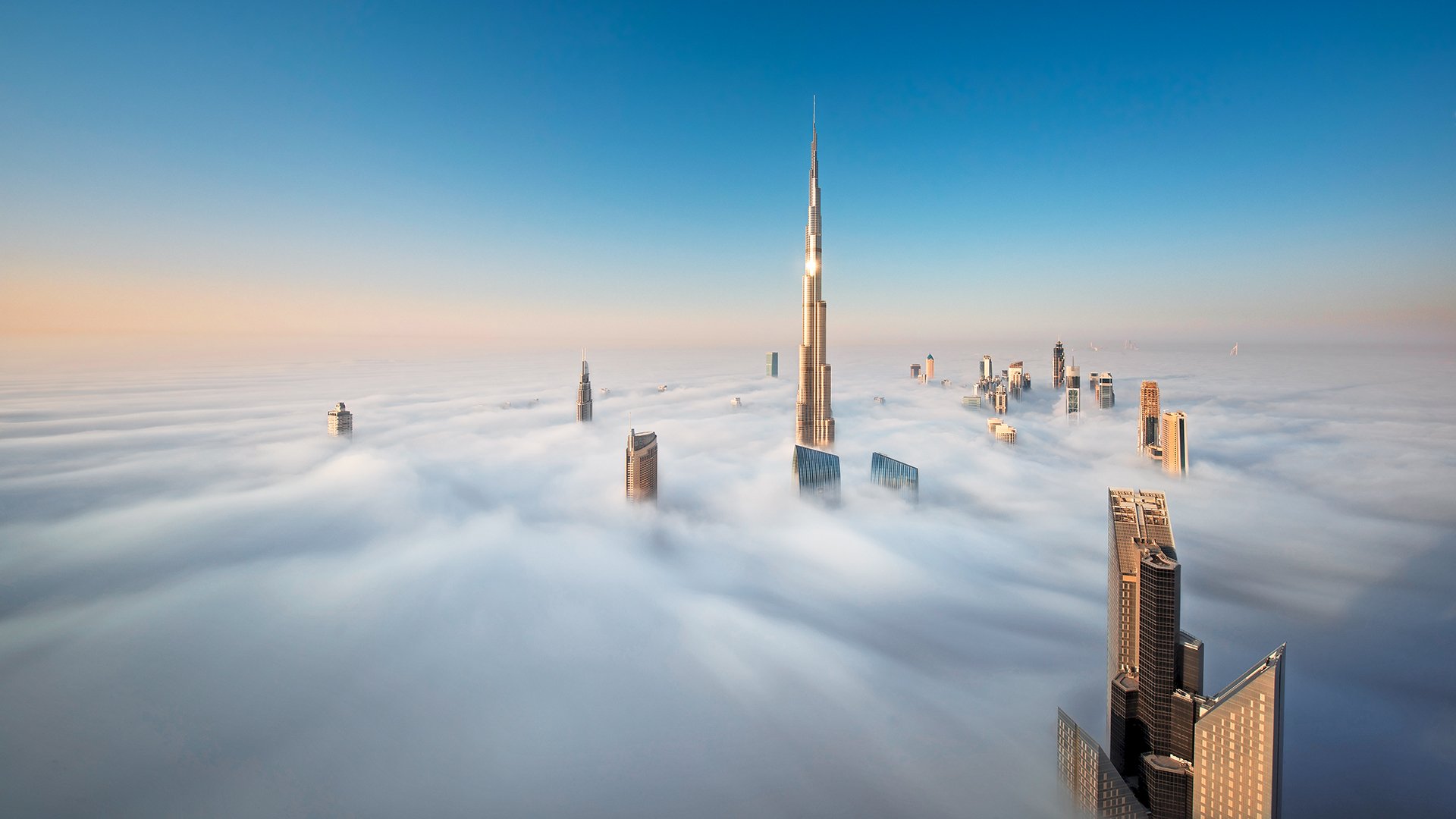 View of the Burj Khalifa and other skyscrapers above the clouds in Dubai, United Arab Emirates.