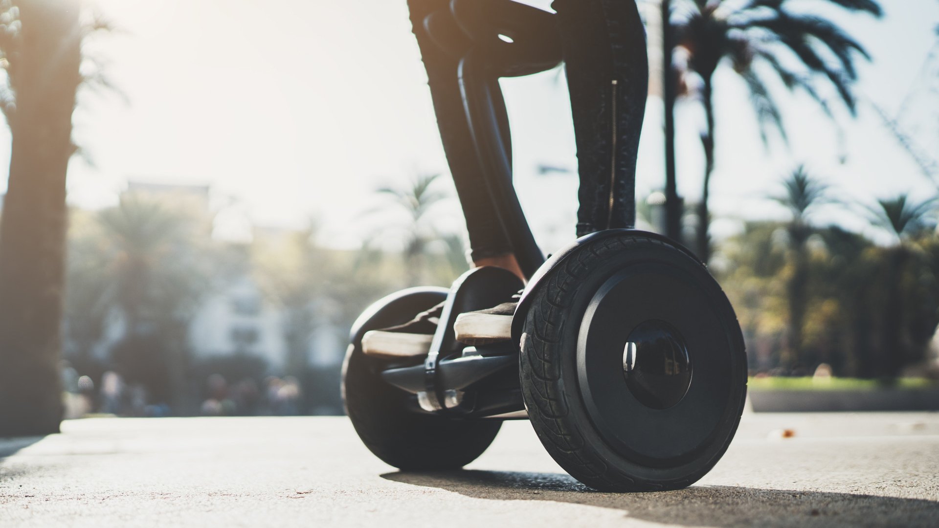 Young hipster girl standing on electric hoverboard at sunny day in Europe, activity holidays, environment and ecology concept, active woman riding self-balancing scooter at holiday, enjoyment lifestyle
