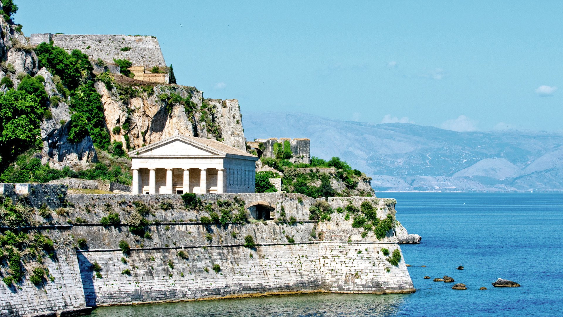 An ancient greek temple and church on the coast of Corfu Greece