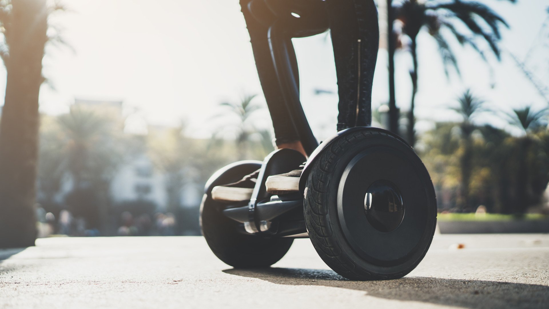 Young hipster girl standing on electric hoverboard at sunny day in Europe, activity holidays, environment and ecology concept, active woman riding self-balancing scooter at holiday, enjoyment lifestyle