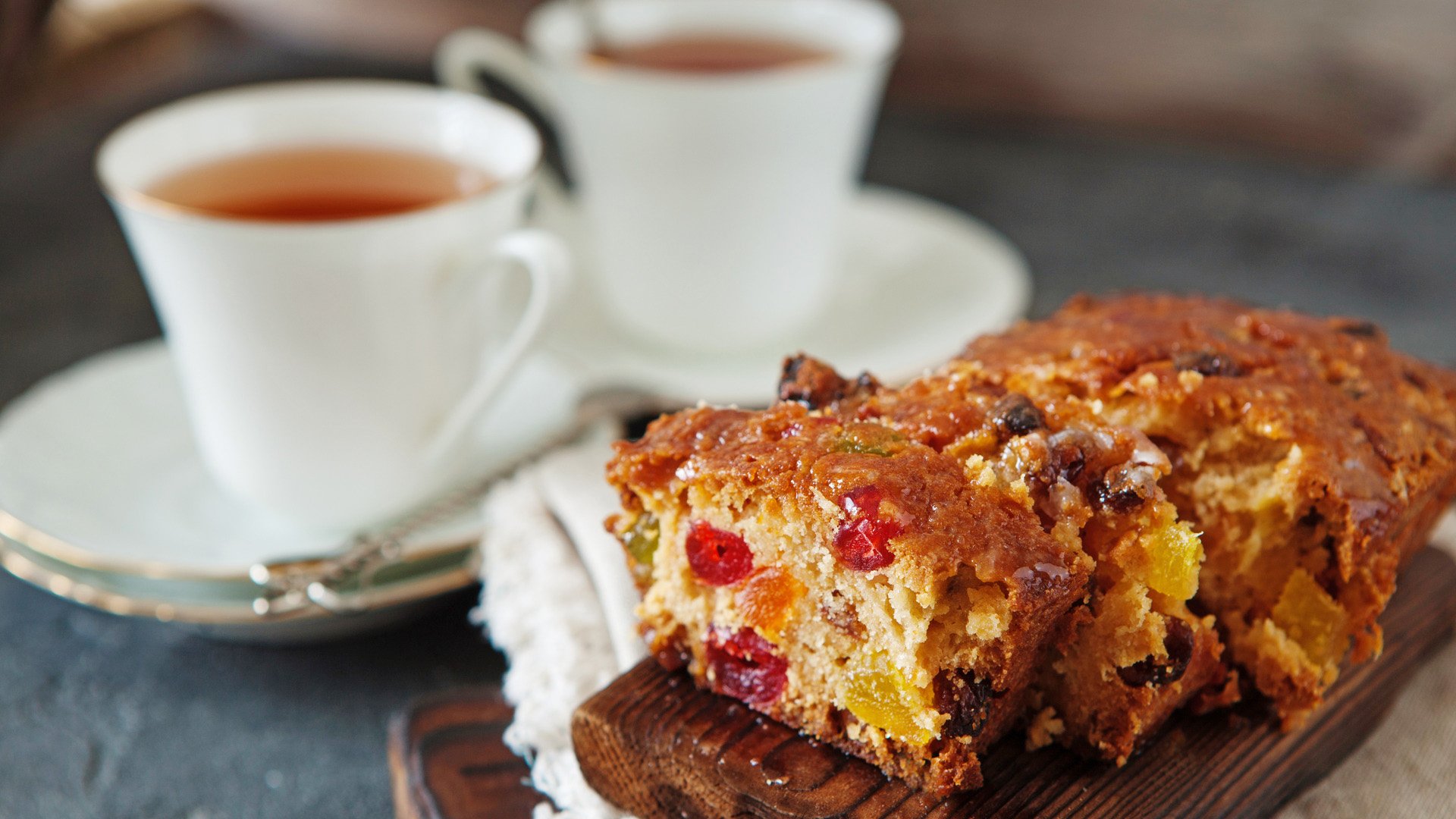 Traditional fruit cake pudding with dried fruits on wooden board copy space