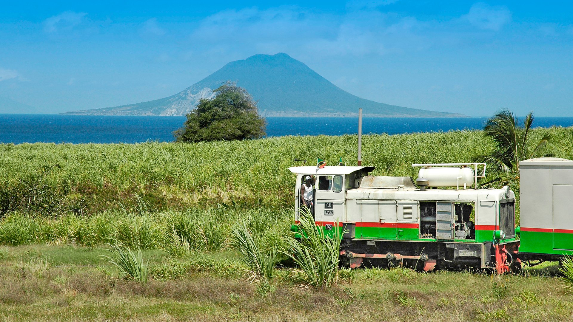 BEGD73 St. Kitts touristic sugar train with Saba island across the sea