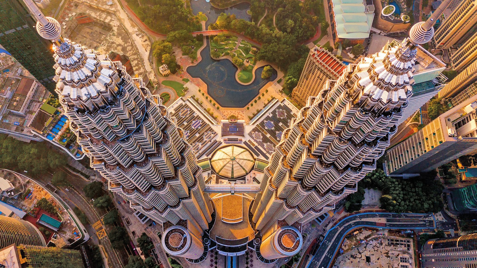Top of Petronas Twin Towers. Aerial view of Kuala Lumpur Downtown, Malaysia. Financial district and business centers in smart urban city in Asia. Skyscraper and high-rise buildings at sunset.