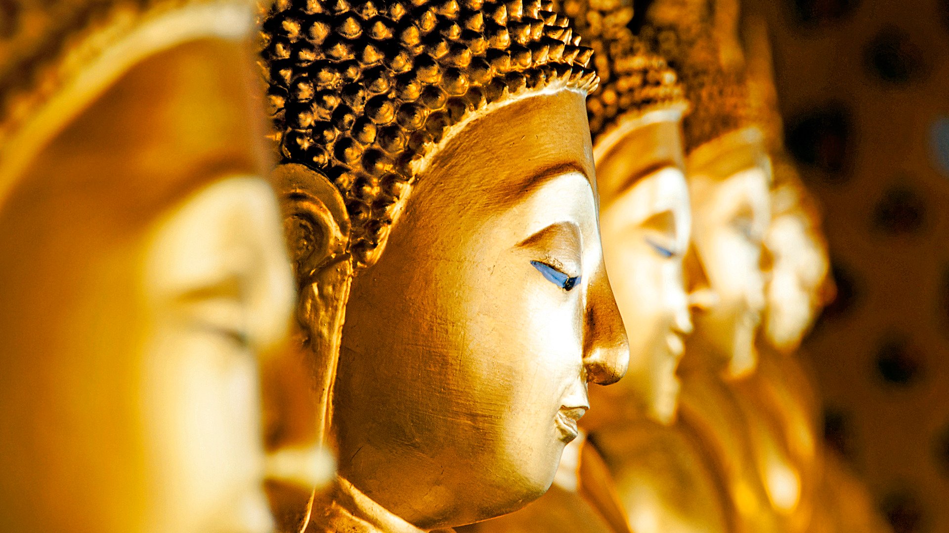 Row of Buddhas at Wat Arun, Bangkok, Thailand.