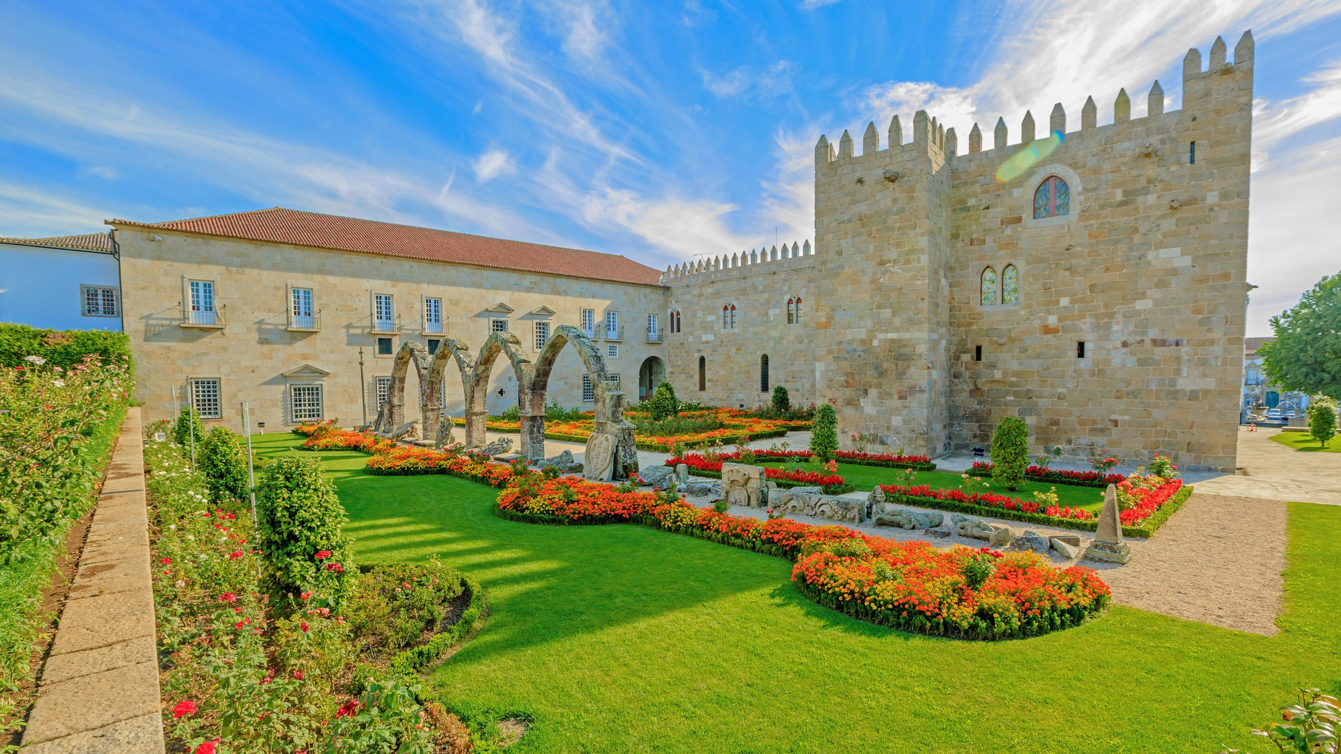 Braga, Portugal. A side of architectural complex of medieval Episcopal Palace of Braga or Paco Episcopal Bracarense in town hall square or Praca do Municipio. Sunny day.