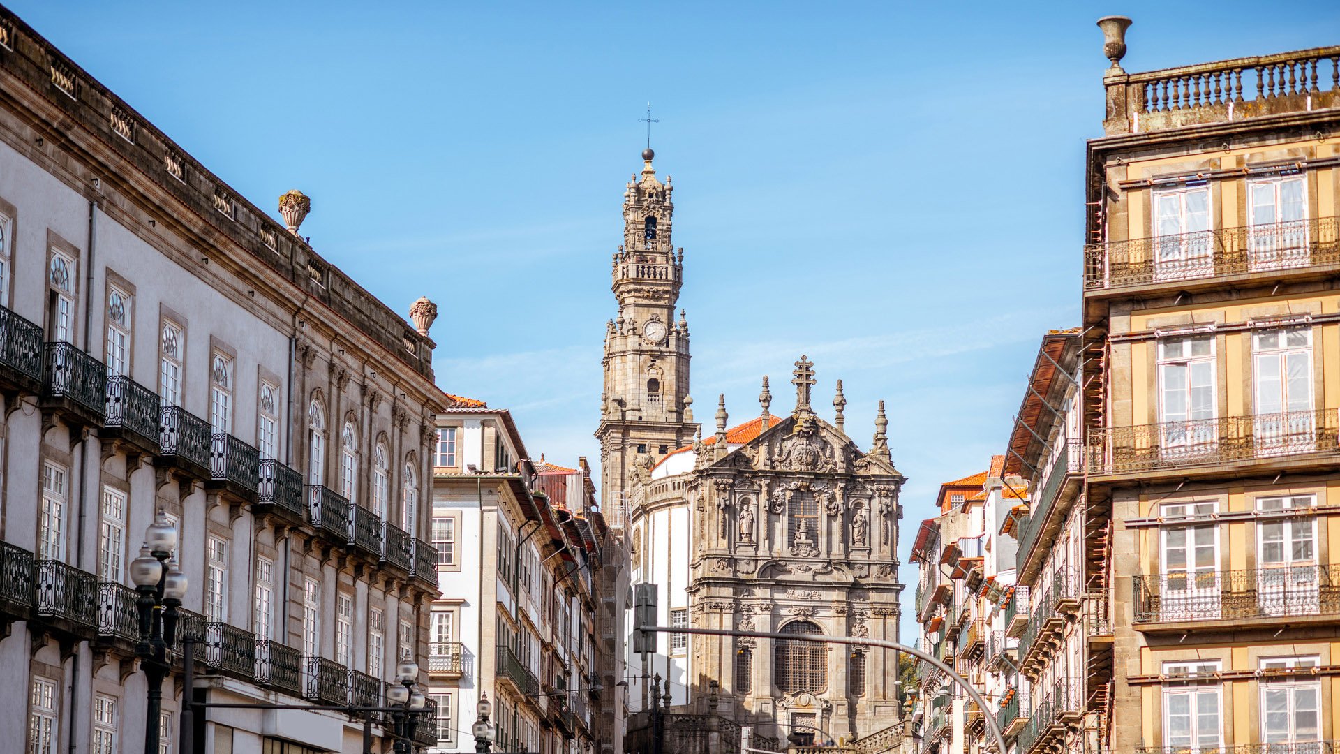 Street view with Clerics church during the sunny day in Porto city, Portugal