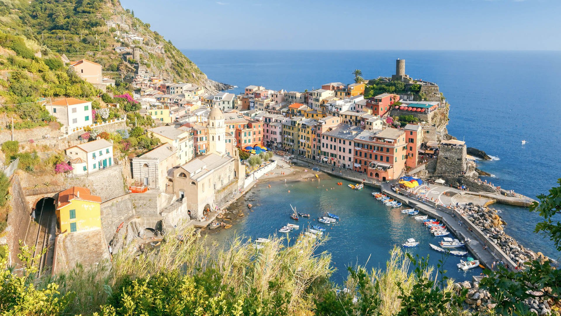 The view from the high hill village of Vernazza and the old harbor at sunset. Cinque Terre National Park. Liguria. Italy.