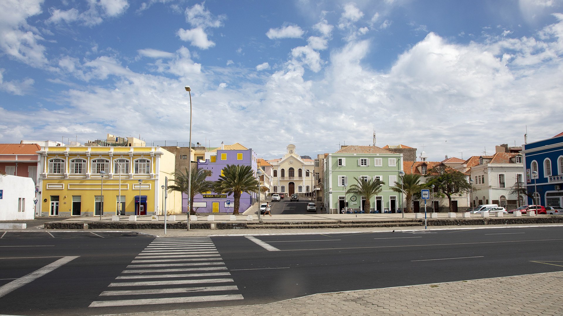 Colonial houses and crosswalk, pedestrian crossing in Mindelo on the island of Sao Vicente in Cape Verde,a beautiful clouded sky.