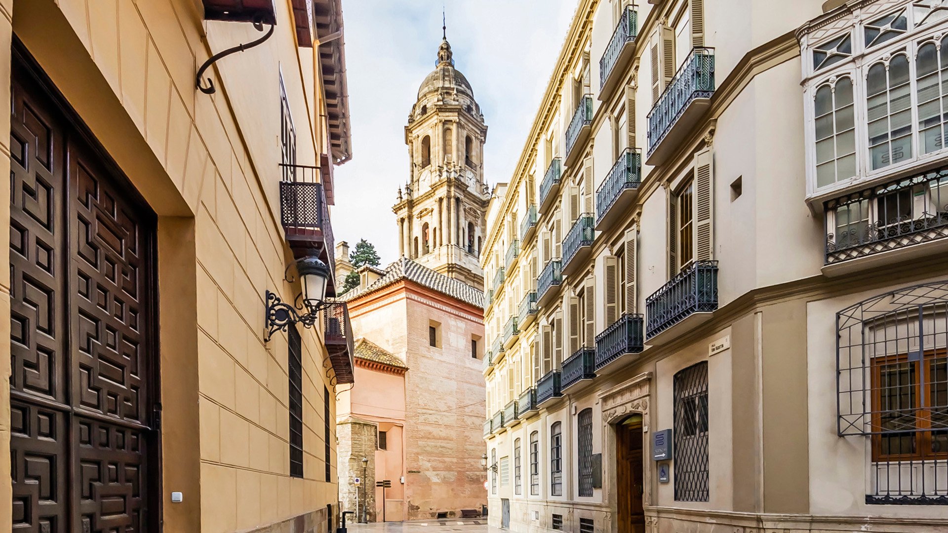 Spain, Andalusia, Malaga, Old town, alley and Cathedral of Malaga in the background