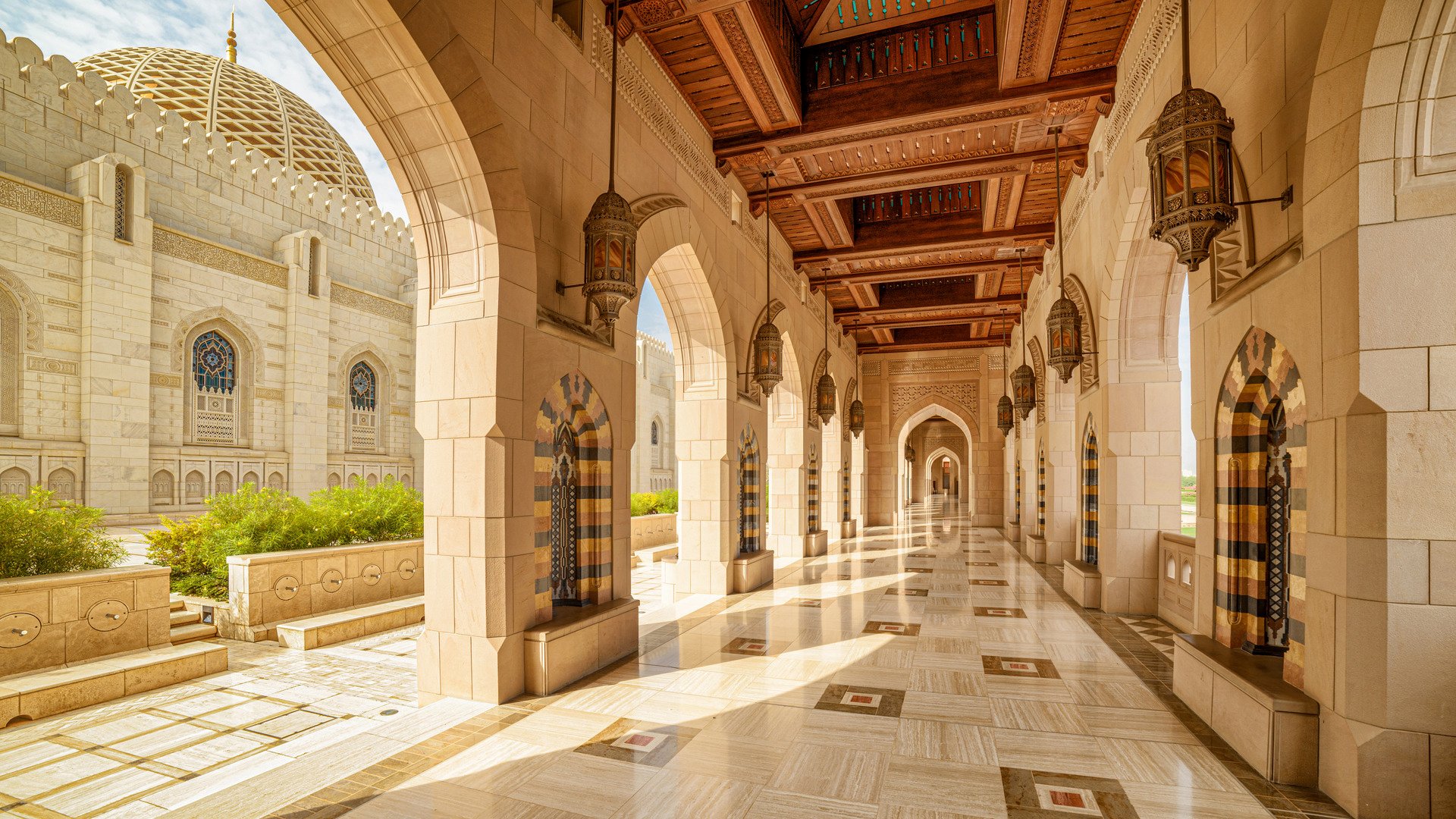 Muscat, Oman - 17 October, 2018: View of deserted arched passageway at the Sultan Qaboos Grand Mosque. Islamic architecture. The Muslim place is a popular tourist attraction of the Middle East.