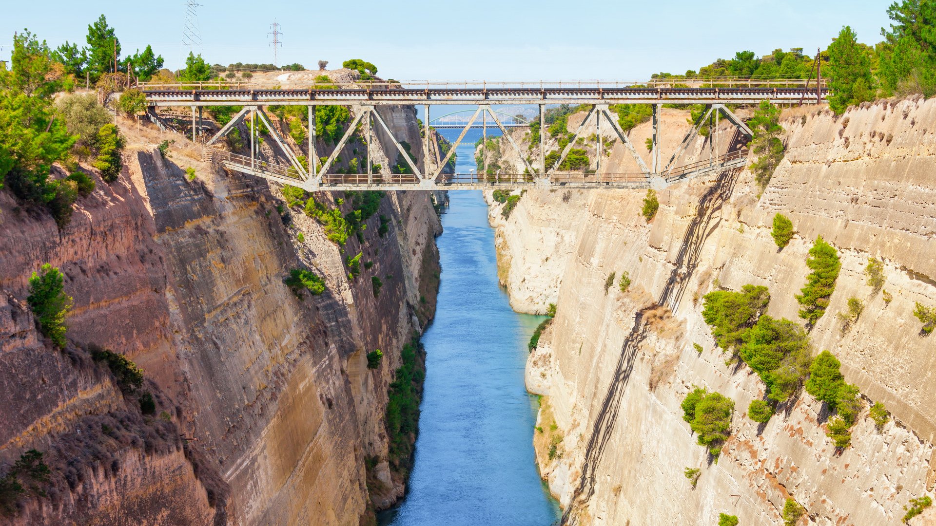 The Corinth Canal is a canal that connects the Gulf of Corinth with the Saronic Gulf in the Aegean Sea. It cuts Isthmus of Corinth and separates Peloponnese from the Greek mainland.