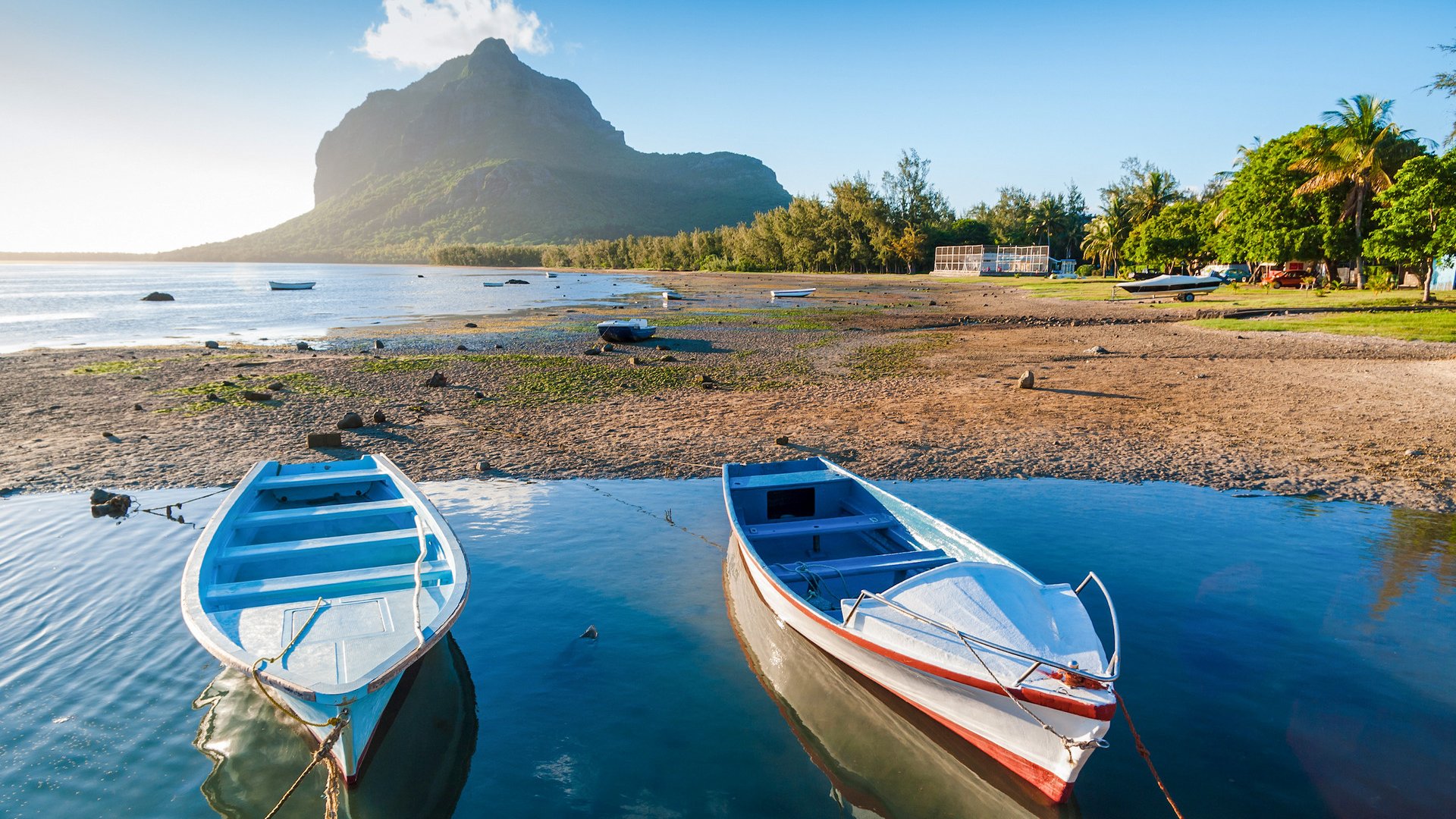 Fishing boats at sunset on the background of the mountain Le Morne Brabant. Mauritius Island