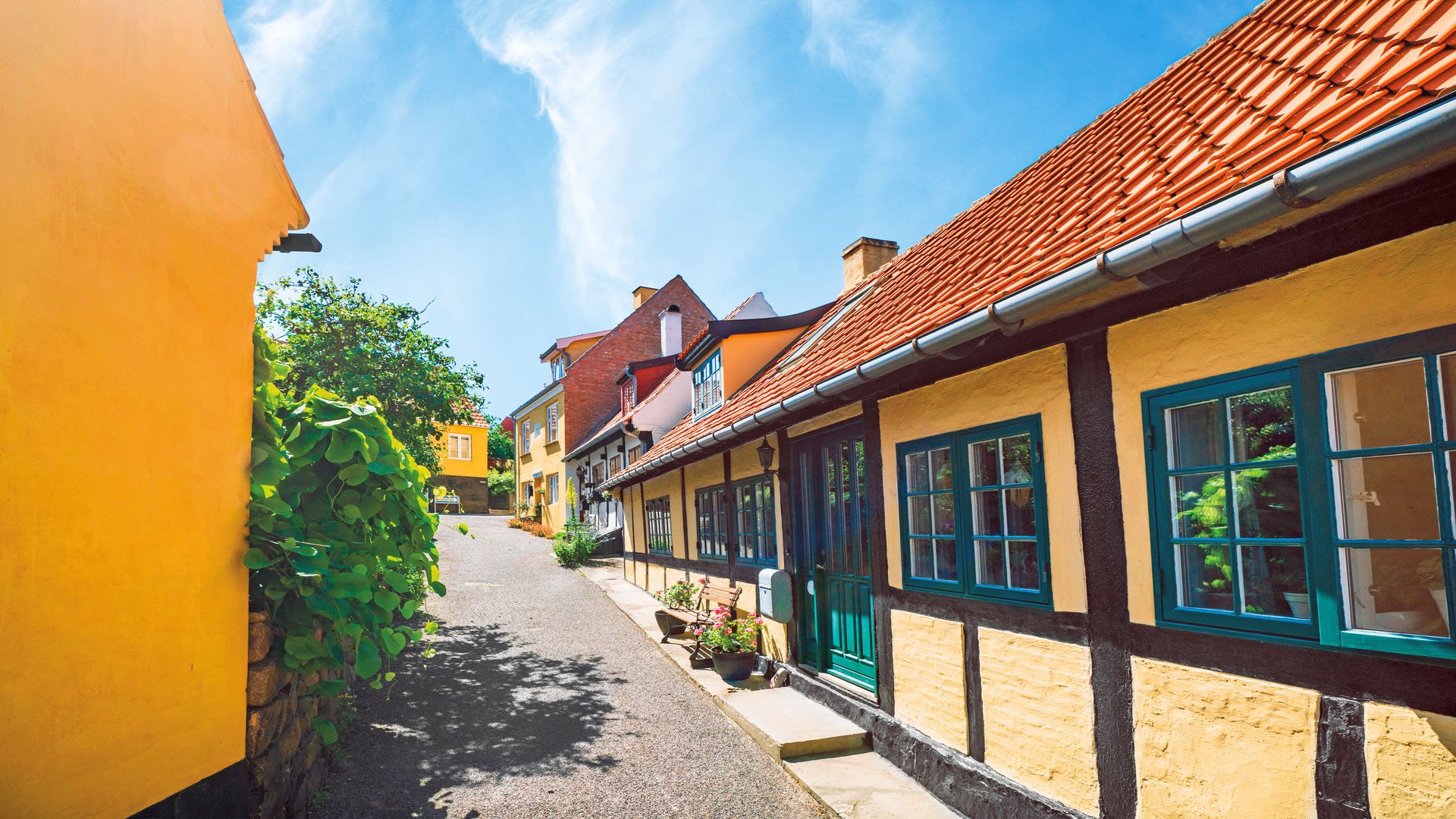 Idyllic village with yellow buildings under a blue sky in the summer