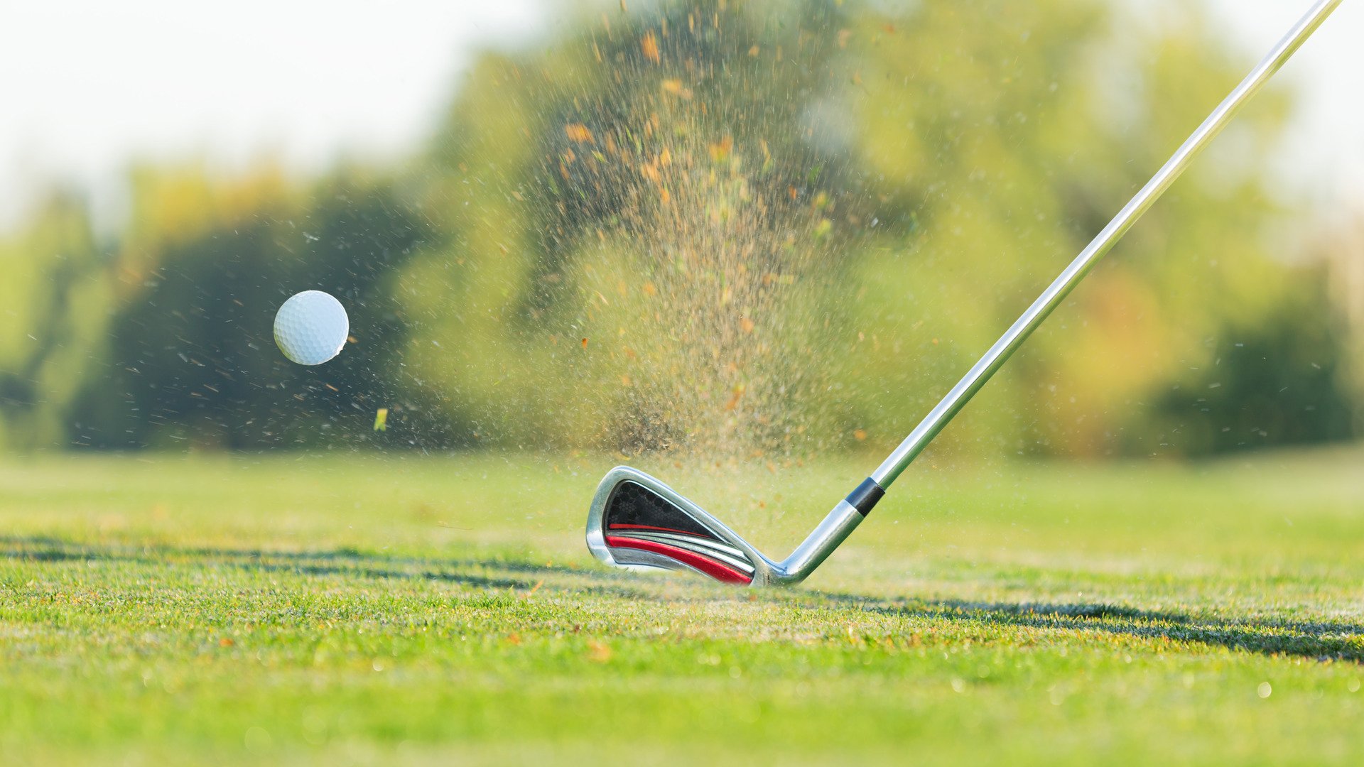 Close-up of golf ball with club during sunset