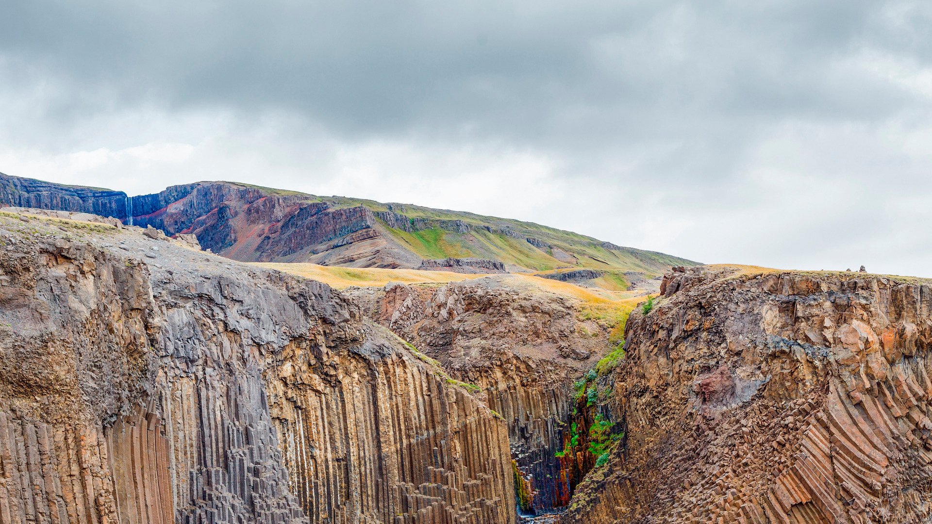 18254122 - panorama of hengifoss is the second highest waterfall on iceland  the most special thing about the waterfall are multicolored layers in the basalt rock behind waterfall
