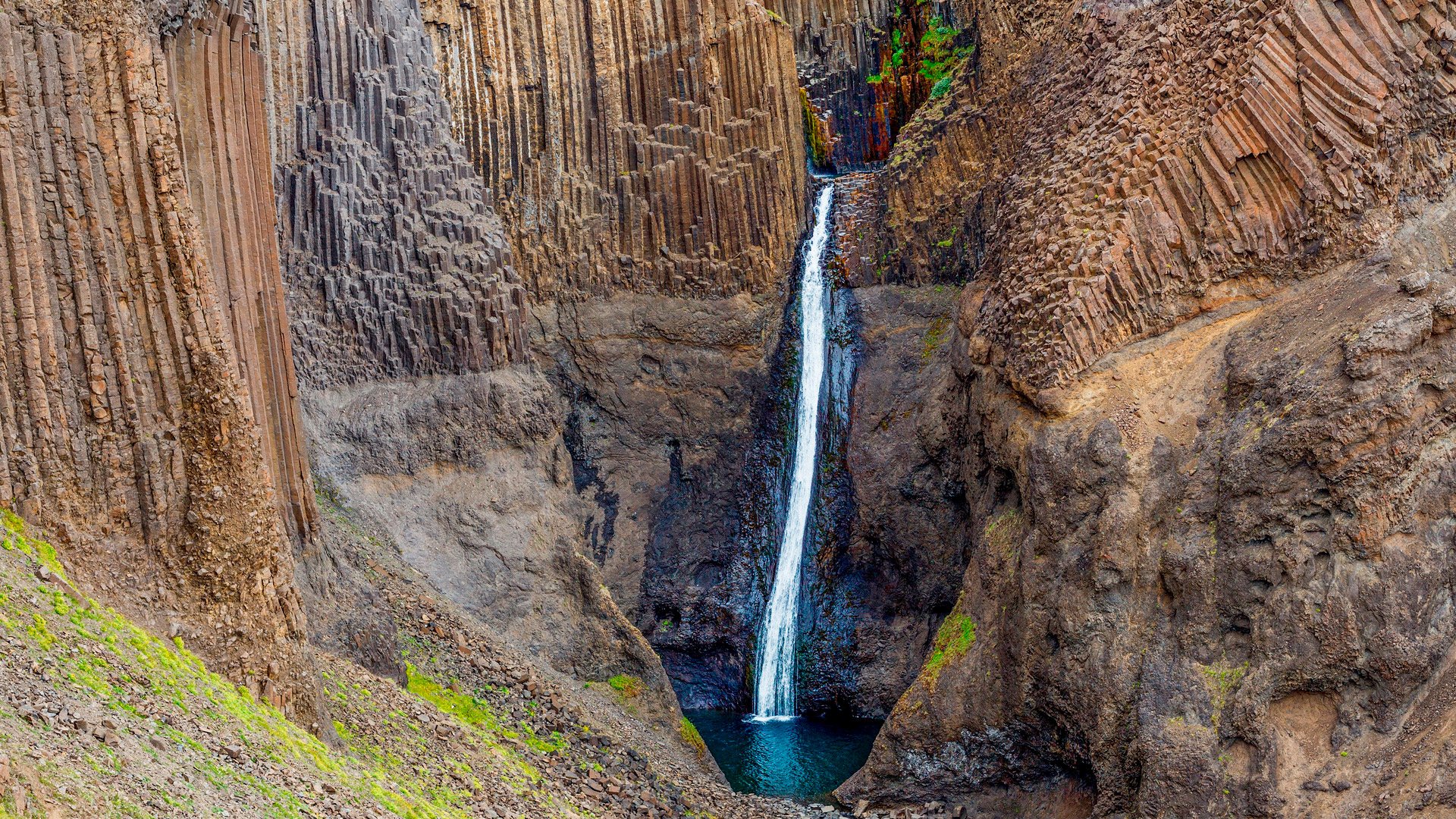 18254122 - panorama of hengifoss is the second highest waterfall on iceland  the most special thing about the waterfall are multicolored layers in the basalt rock behind waterfall
