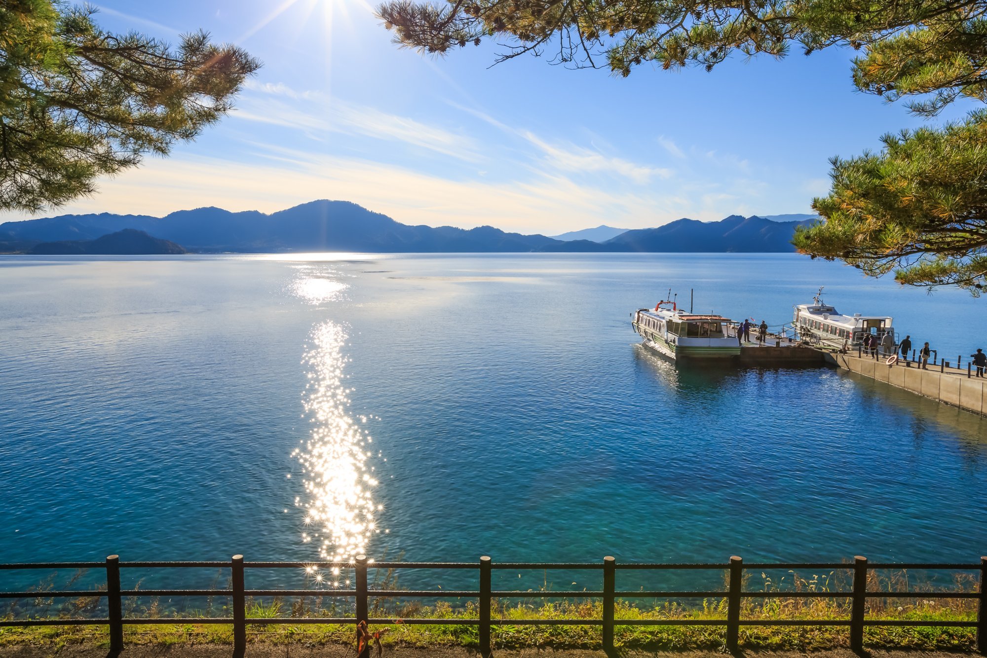 Passenger ships with sparkling sunshine in Lake Tazawa - Senboku, Akita, Japan; Shutterstock ID 378875515; purchase_order: BB23-28333 at; job: ; client: AIDA Cruises; other: 