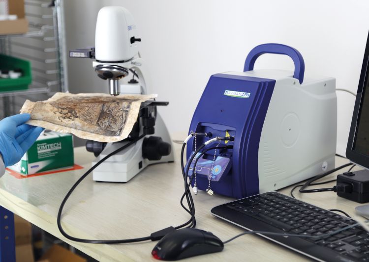 The i-Raman Plus Portable Raman Spectrometer being used to investigate artwork.